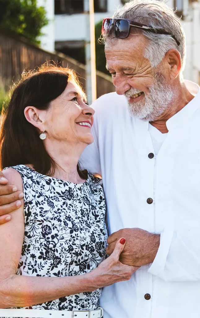 portrait of senior couple smiling at each other secure retirement future